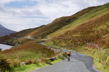 Cyclist on the road R335, near Tawnyinlough, Leenaun and Aasleagh Falls, County Mayo, Ireland