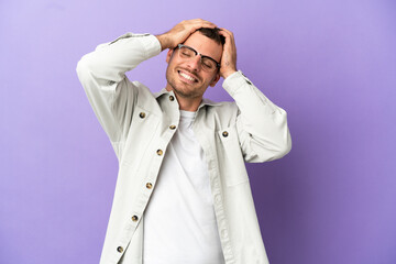 Brazilian man over isolated purple background laughing