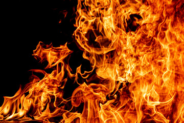 Fire flame texture. Burning material backdrop. Burn effect pattern. Blaze and torch wallpaper. Heat and haze backdrop.