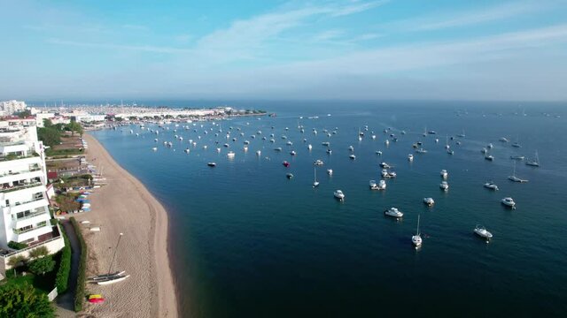 Aerial forward over multitude of boats moored at Arcachon beach, France