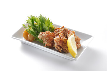  Fried chicken karaage with a lemon, Japanese food in white plate isolated on white background.