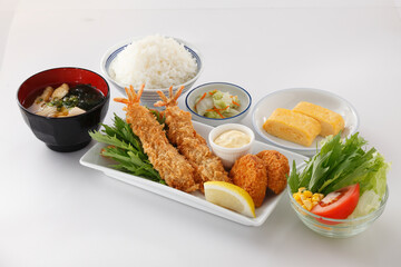 Crispy Breaded Prawns, deep-fried shrimp or Ebi Furai Japanese food set with korokke Japanese Mashed  Potato croquettes and rice,soup,sweet omelette and vegetable salad on white background.