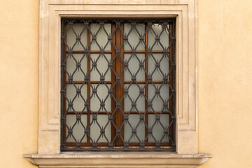 A lattice window decorated with an ornament.