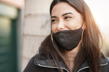 Beautiful young latin woman wearing safety face mask for coronavirus outbreak