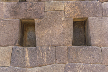 inca ruins in the sacred valley carved in granite windows bumps and stone walls located in ollantaytambo cusco peru on a sunny day with blue sky - obrazy, fototapety, plakaty