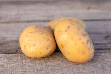 potatoes on a wooden background, concept agriculture.