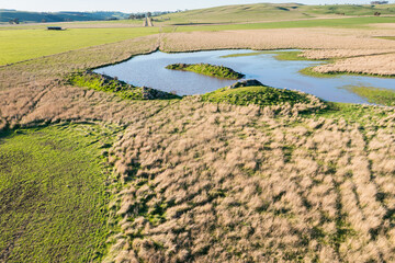 drone shot of farming landscape on a ranch in Australia, of a flooding river.