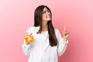 Young scientific girl over isolated pink background pointing up a great idea