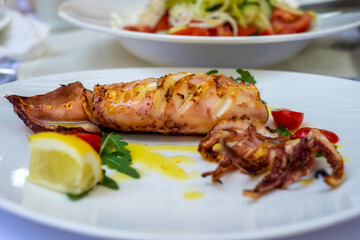 Grilled squid with lemon and cherry tomatoes in Thassos, Greece