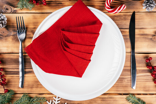 Step-by-step tutorial: Fold linen napkin in shape of Christmas tree. Step 5: Fold one side at angle as shown on image