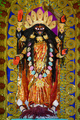 Idol of Goddess Maa Kali at a decorated puja pandal in Kolkata, West Bengal, India. Kali puja also...