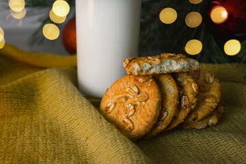 treats for santa claus. round cookies with nuts on the background of the christmas tree