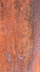 rusty old metal steel structure old west wall with rust and bullet holes vertical architectural...