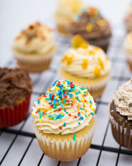 cupcake with sprinkles on a marble background on a grid