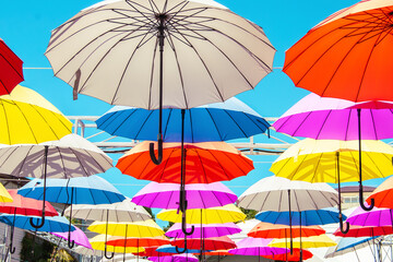 Colorful flying umbrellas suspended outdoors. nterior decoration, an interesting solution.