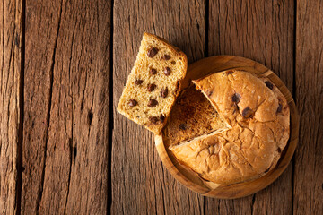 Delicious panettone with chocolate chips on a wooden table. Chocottone