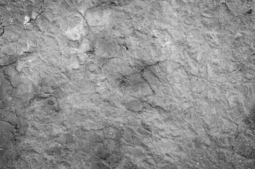 Black and white photo of old concrete wall with a lot of crackles for texture and background concept
