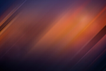 Soft and blurred orange, purple and bluish background. Abstract vibrant multi-colored dark background. Motion blur. Copy space.