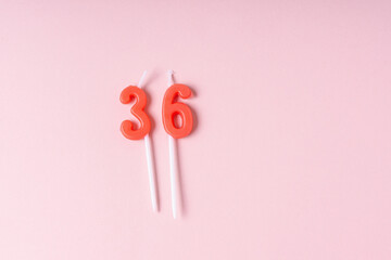 Festive number red 36 candles. Pink background. Space for text