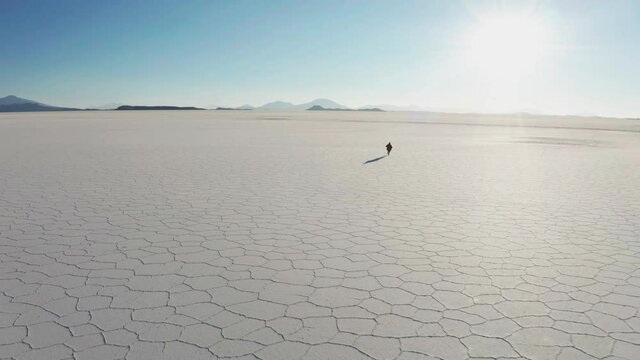 Man in poncho at Salar de Uyuni, Aitiplano, Bolivia. Traveling in Bolivia.