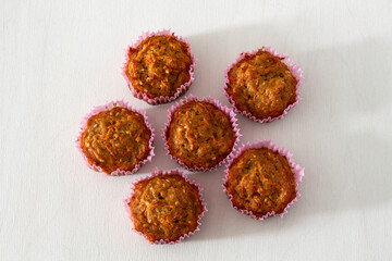 Sweet homemade carrot muffins on white background