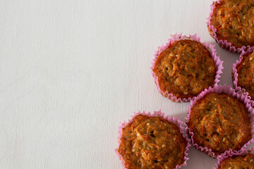 Sweet homemade carrot muffins on white background with copy space