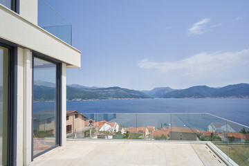 Fototapeta na wymiar Glass balcony of a private house with sea and mountain views
