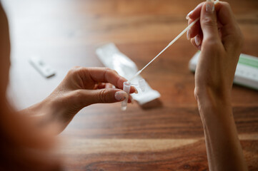 Dipping swab stick of covid19 self home test in a testing solution