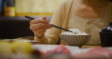 Woman eat her rice in japanese restaurant