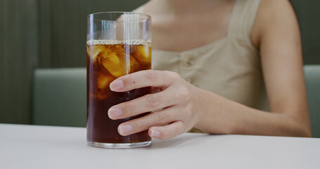 Woman enjoy her iced coffee in cafe