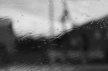 View through the rain-drenched side window of the car.