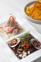 Duo of Peruvian ceviche, black shells and classic fish ceviche.
