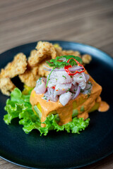 Causa acevichada, accompanied by fried fish.
