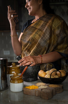 Woman in sari cooking in the kitchen 