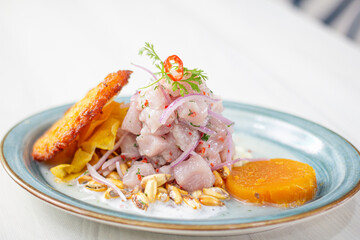 Peruvian eviction, accompanied by sweet potato, chili, corn cake.
