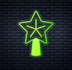 Glowing neon Christmas star icon isolated on brick wall background. Merry Christmas and Happy New Year. Vector