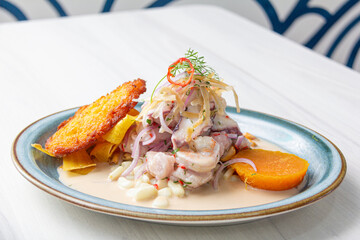 Peruvian eviction, accompanied by sweet potato, chili, corn cake.
