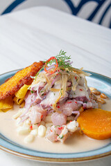 Peruvian eviction, accompanied by sweet potato, chili, corn cake.
