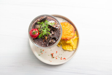 Panther milk, accompanied by black shells and fish.
