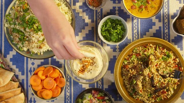 Eating bulgur with eggplant and hummus top view. Falafel, bean soup, couscous with chicken. Traditional middle eastern culture. Moutabal and vegetable salad in bowls. Delicious rice with meat.