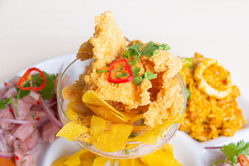 Perfect combo of Peruvian ceviche, with corn cakes and seafood rice.
