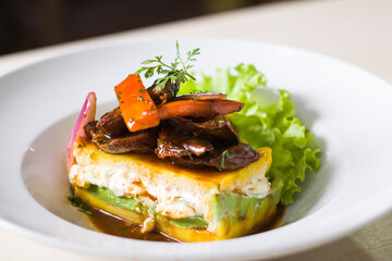 Causa accompanied by lomo saltado
