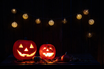 halloween - Jack O' Lanterns - Candles And String Lights On Wooden Table