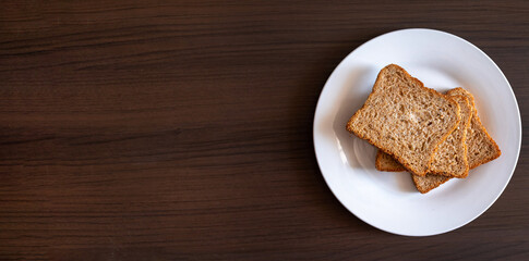 Wholemeal bread on a wooden background