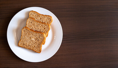 Wholemeal bread on a wooden background
