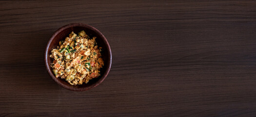Scrambled eggs on a wooden background