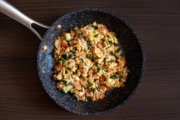 Scrambled eggs on a wooden background