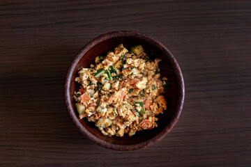 Scrambled eggs on a wooden background