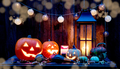 halloween - Jack O' Lanterns - Candles And String Lights On Wooden Table