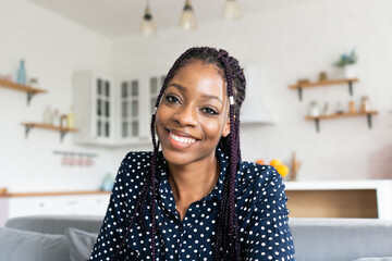Portrait young black woman webcam online call smiling happy braids
